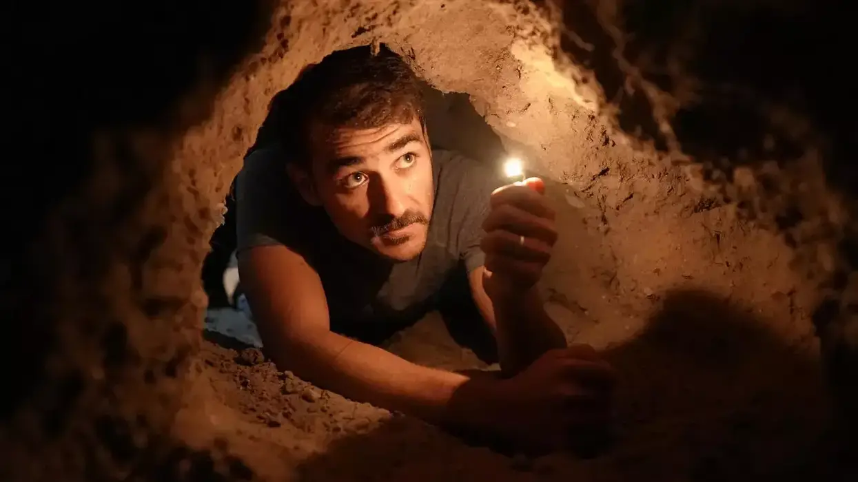 A reenactment from the film Palestinian Prison Break shows a prisoner trying to dig a tunnel out of a facility.