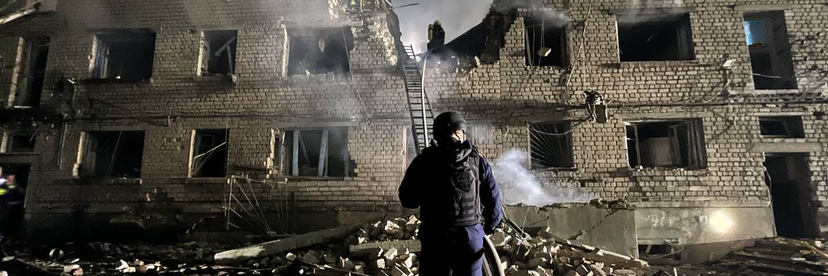 A rescue worker stands in the rubble in Ukraine.