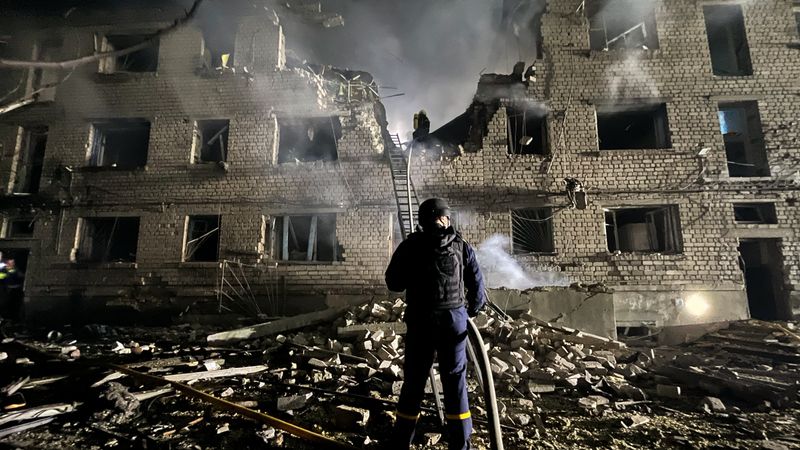 A rescue worker stands in the rubble in Ukraine.