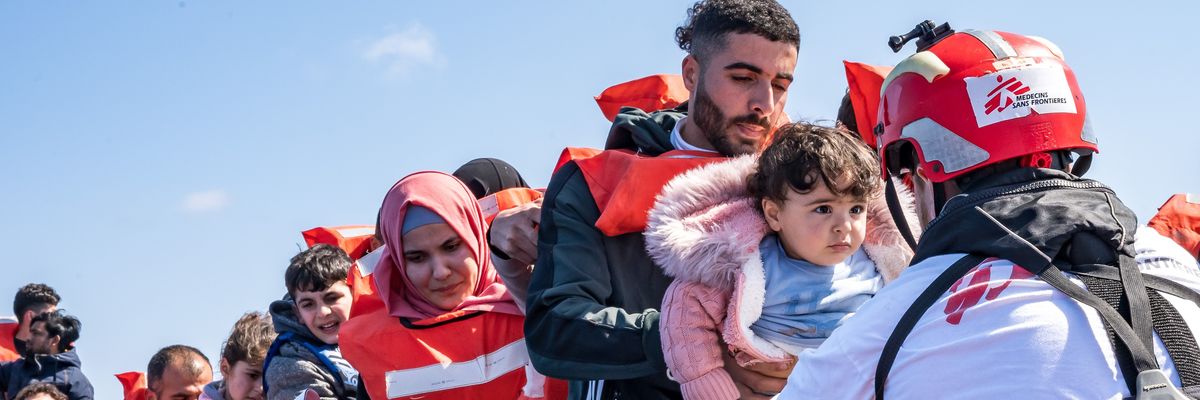 A rescued child embarks on Geo Barents, a rescue vessel operated by Doctors Without Borders