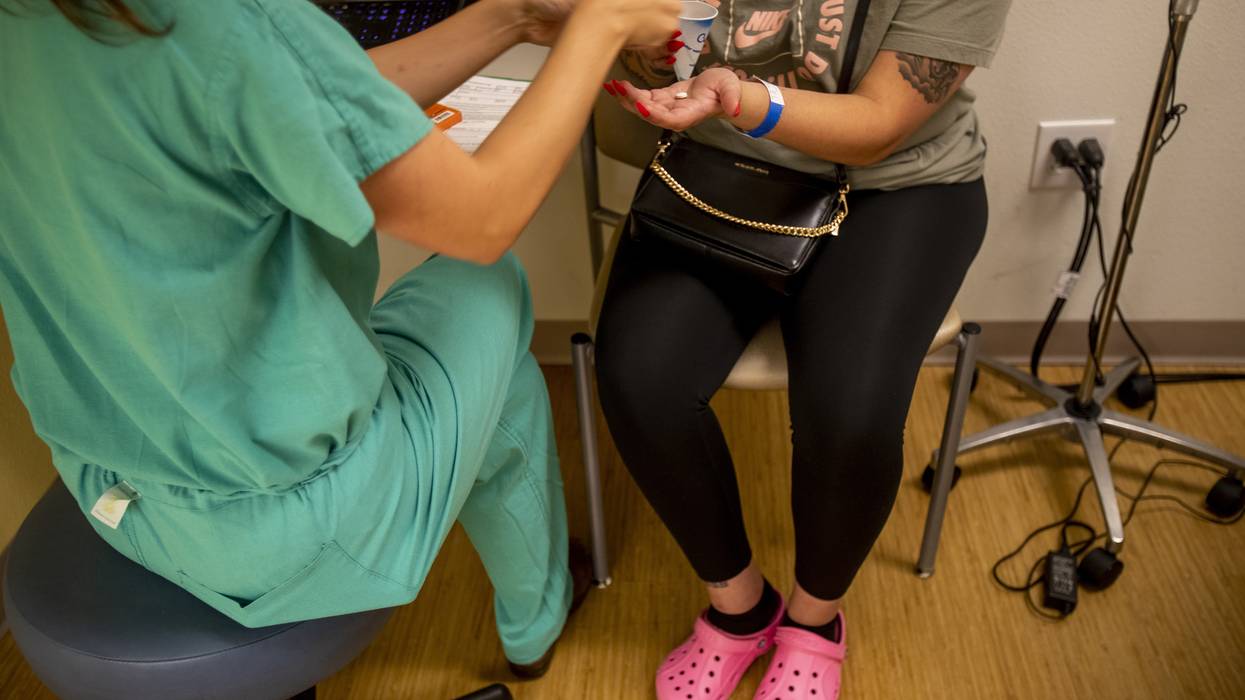 A resident gives a 25-year-old woman medication to terminate her pregnancy