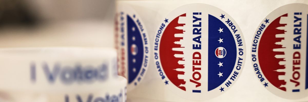 A roll of early voting stickers is shown.