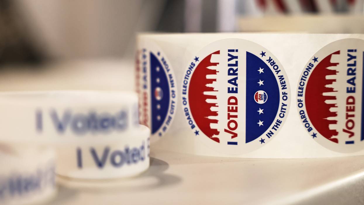 A roll of early voting stickers is shown.