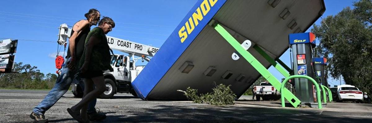 A rooftop of a Sunoco gas station rests on the ground after being damaged by Hurricane Helene