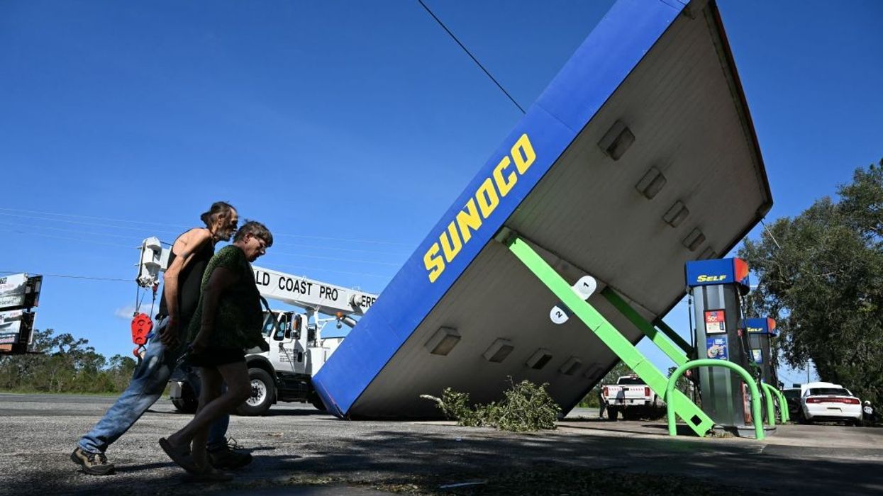 A rooftop of a Sunoco gas station rests on the ground after being damaged by Hurricane Helene