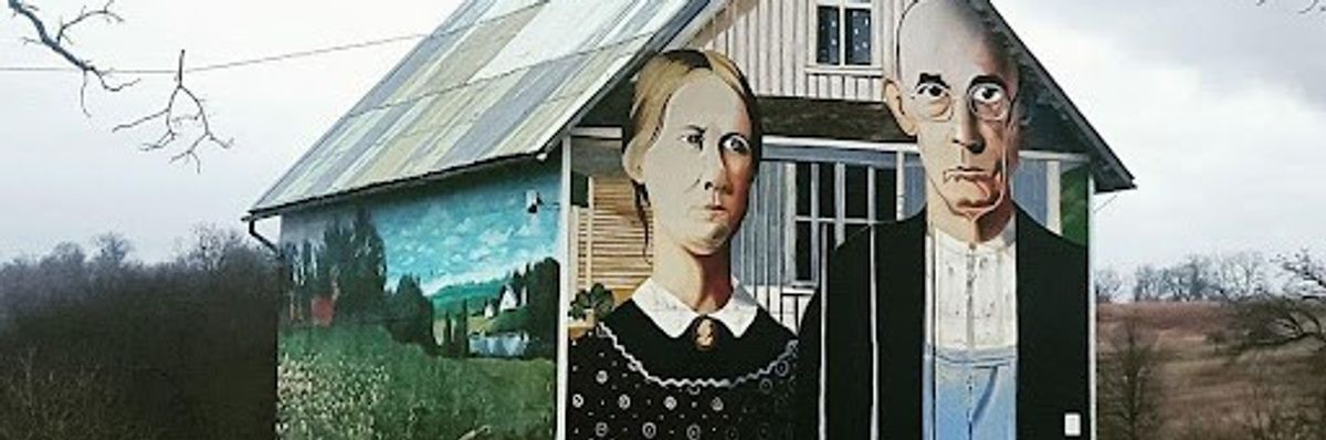 ​A rural house is painted with “American Gothic” by Grant Wood.