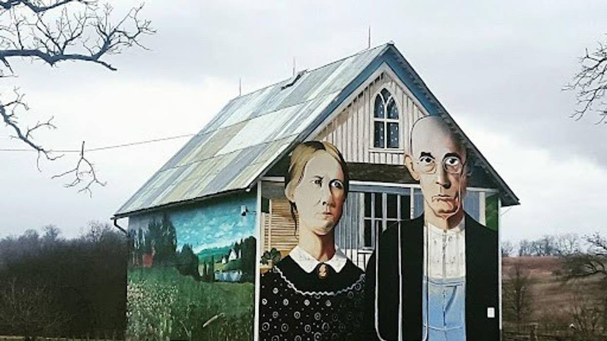 A rural house is painted with “American Gothic” by Grant Wood.
