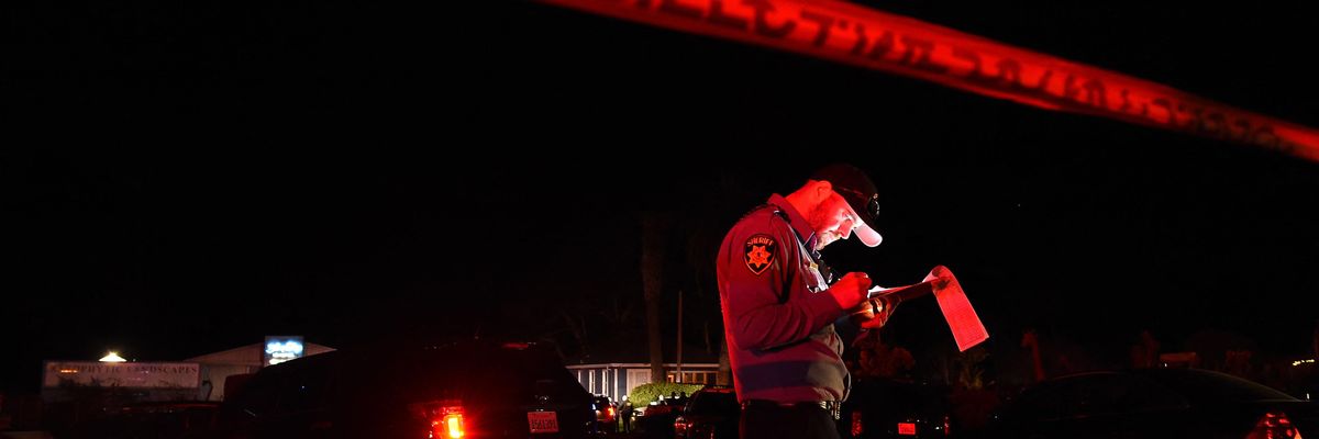 A San Mateo County sheriff deputy stands at the scene of a shooting in Half Moon Bay, California