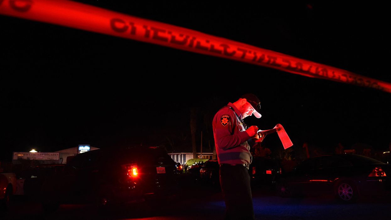 A San Mateo County sheriff deputy stands at the scene of a shooting in Half Moon Bay, California