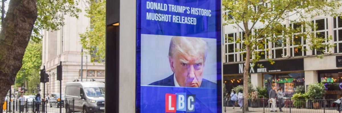 A screen display in London of Trump's mugshot.
