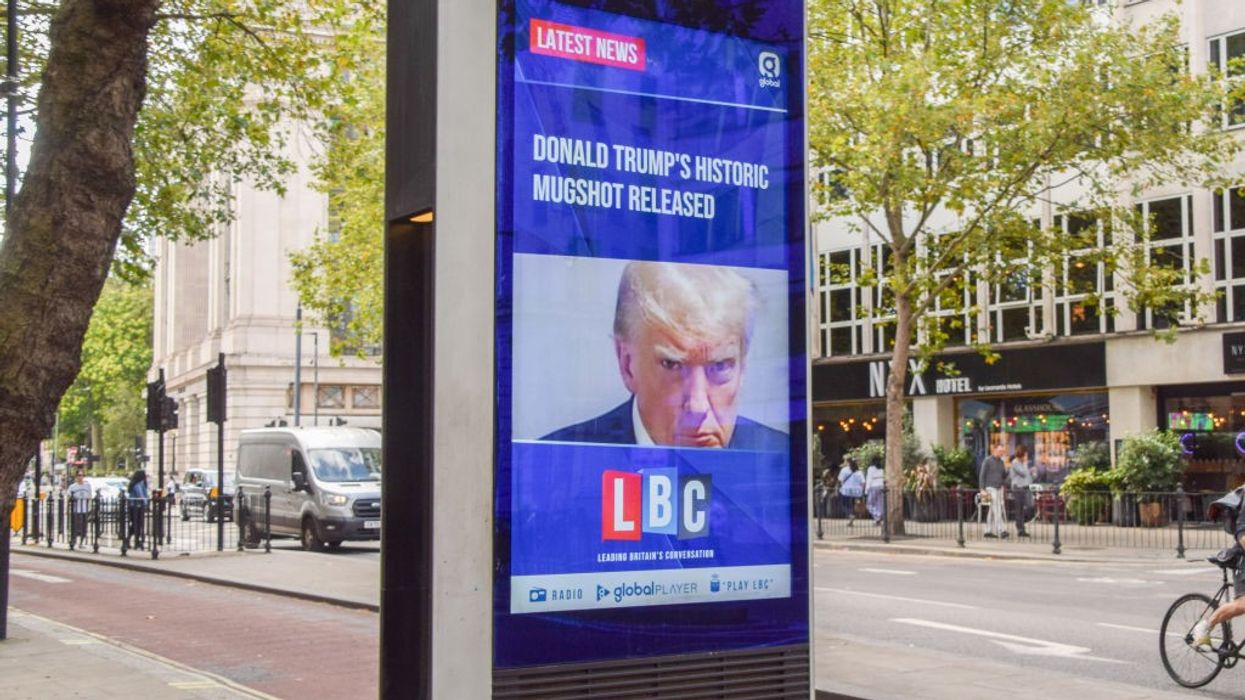A screen display in London of Trump's mugshot.
