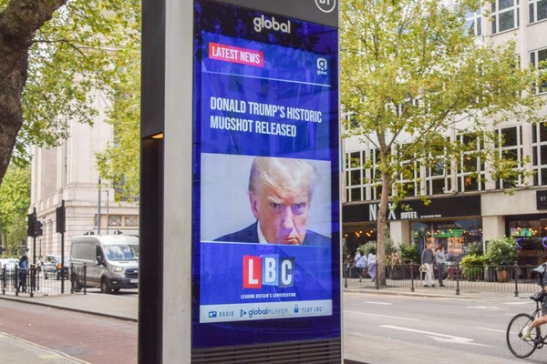 A screen display in London of Trump's mugshot.
