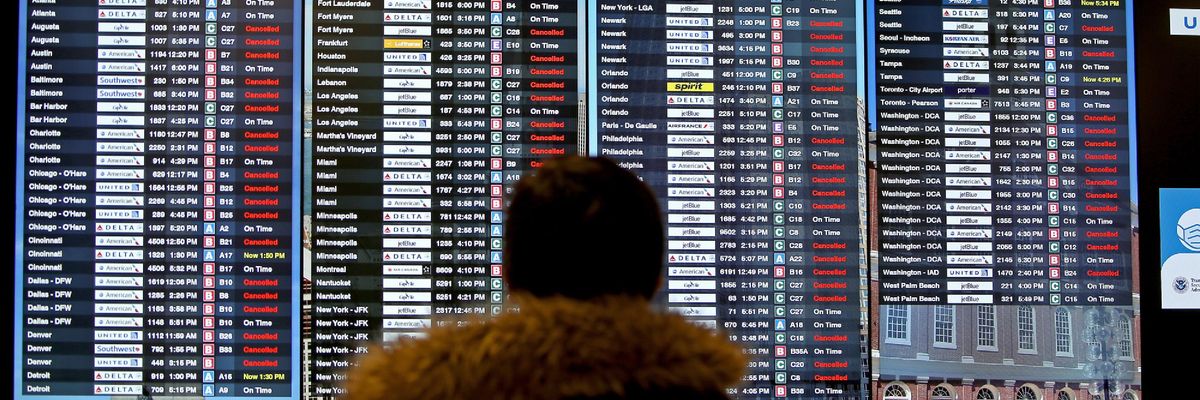 A screen shows canceled flights at Boston's airport