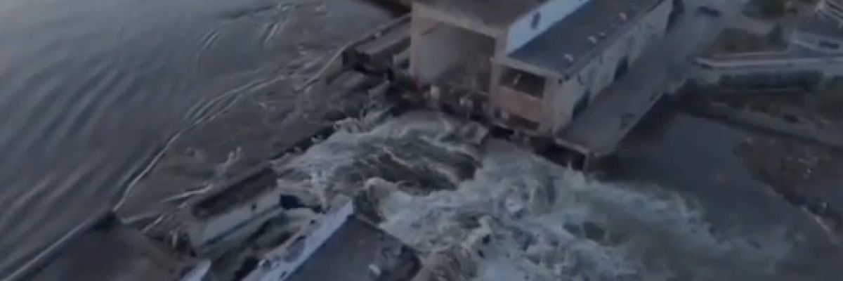 A screengrab captured from a video shows water surging through a breach in the Kakhovka Dam
