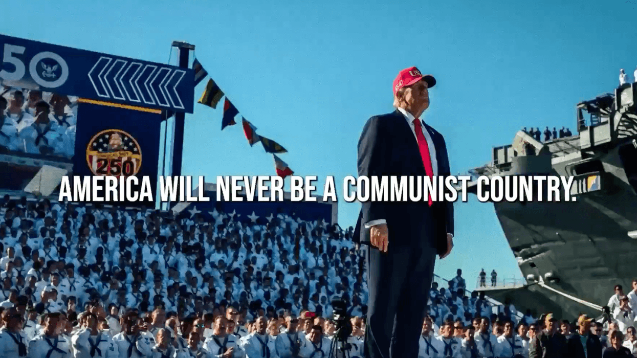 A screenshot of Trump's "Love Me" ad shows him standing before hundreds of troops in a red MAGA hat