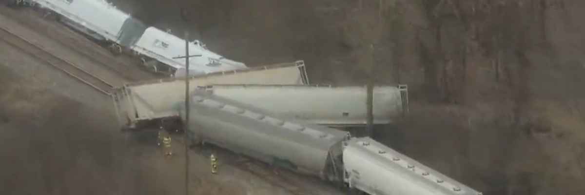A screenshot of video footage shows a derailed train in Van Buren Township