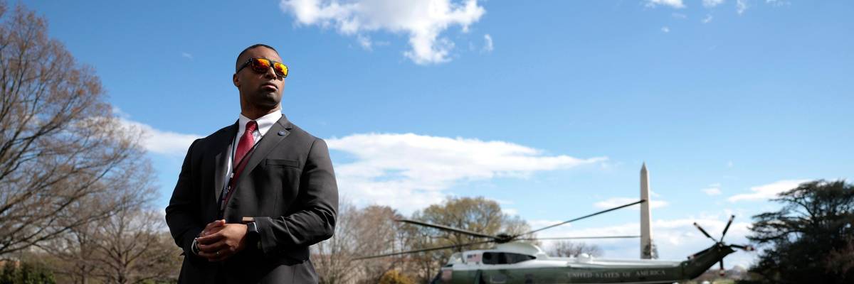 A Secret Service Agent looks on as Marine One, carrying U.S. President Joe Biden lifts off from the South Lawn of the White House on April 01, 2022 in Washington, DC. President Biden is spending the weekend at his home in Wilmington, Delaware. (Photo by Anna Moneymaker/Getty Images)