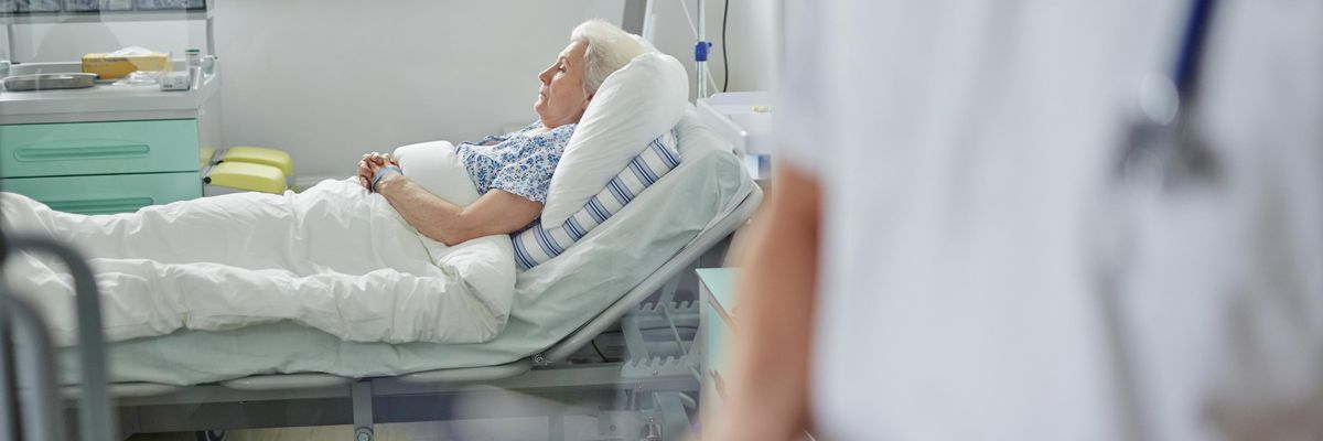 A senior woman is pictured in an intensive care unit