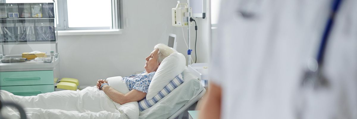 A senior woman is pictured in an intensive care unit