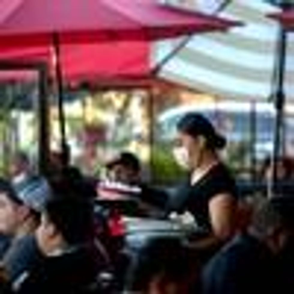 A server clears a table as patrons dine outdoors at Gloria's Cocina Mexicana in Ontario, California on December 5, 2020. (Photo: Watchara Phomicinda/MediaNews Group/The Press-Enterprise via Getty Images)