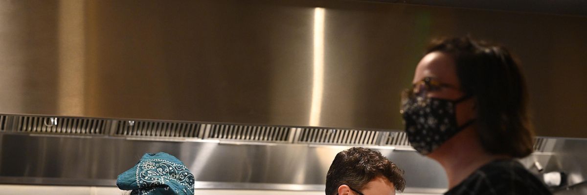 A server walks past the kitchen at Leeward in Portland, Maine on February 23, 2022.