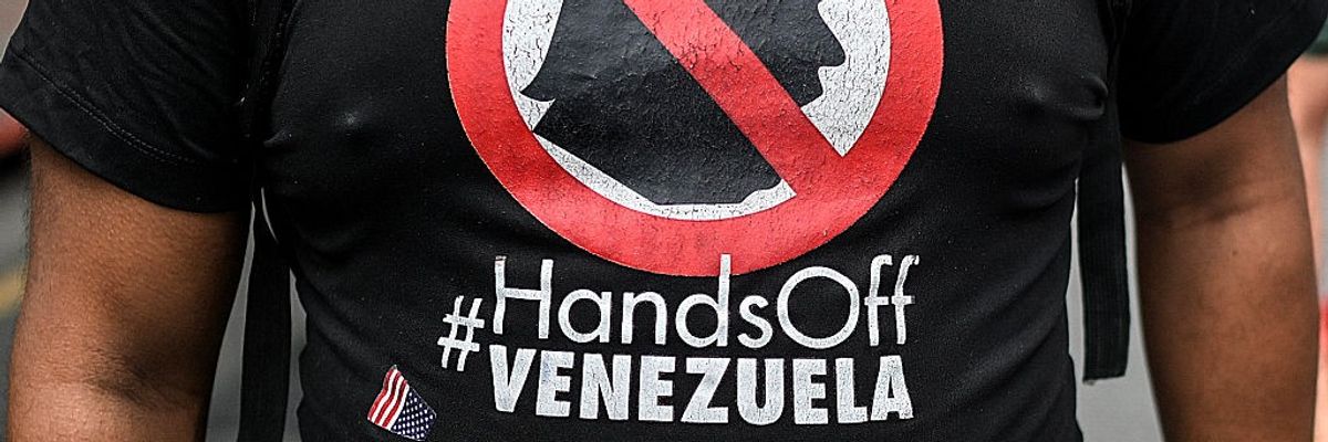 A shirt reads "Hands Off Venezuela" and shows an image of Trump being crossed out.