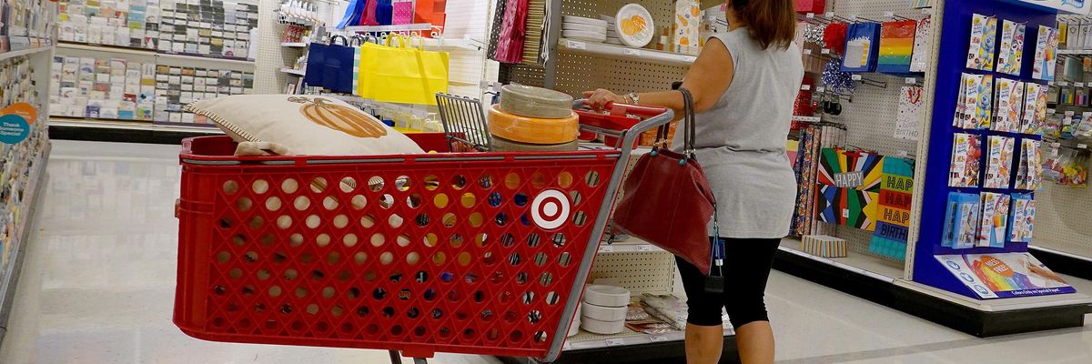 A shopper looks at a price tag at Target.