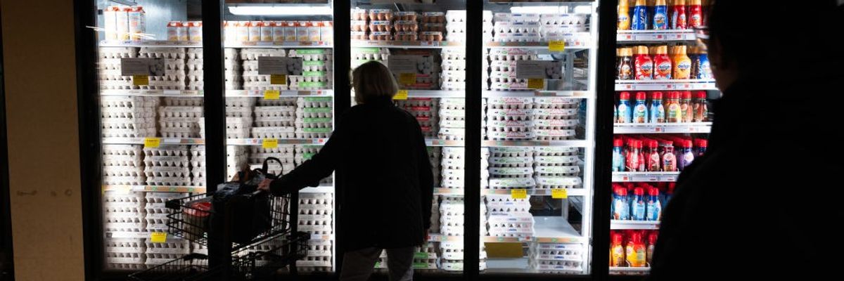 A shopper looks at eggs on sale.