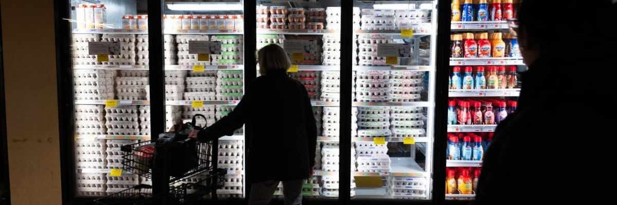 A shopper looks at eggs