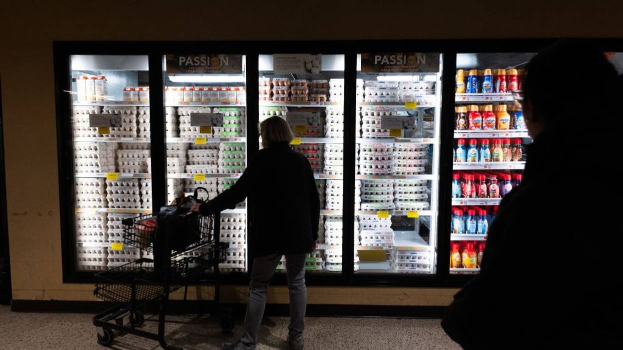 A shopper looks at eggs