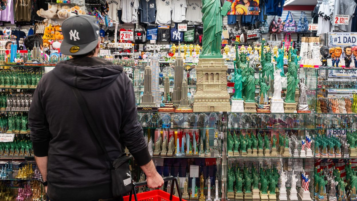 A shopper looks at Statue of Liberty replicas.