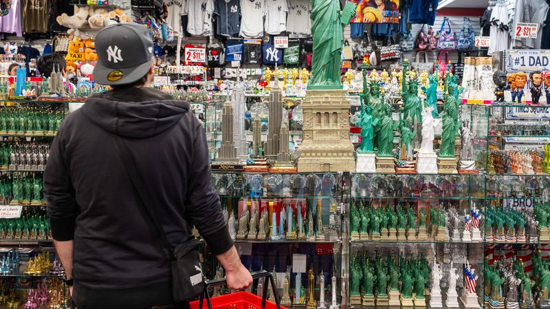 A shopper looks at Statue of Liberty replicas.