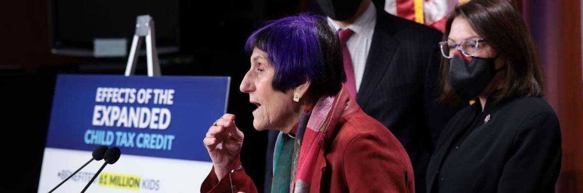 A side view of Rosa DeLaura speaking at a podium.