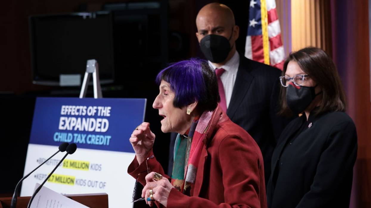 A side view of Rosa DeLaura speaking at a podium.