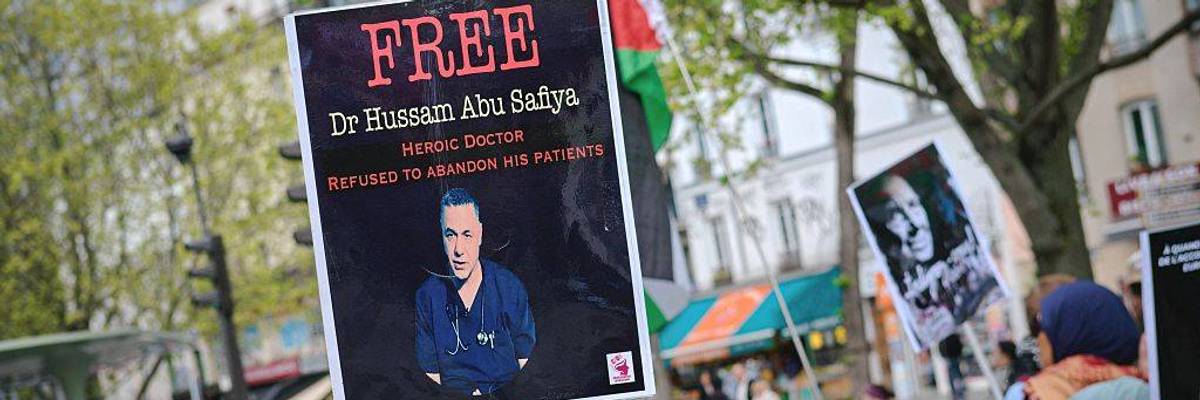 A sign calls for the release of Dr. Hussam Abu Safiya