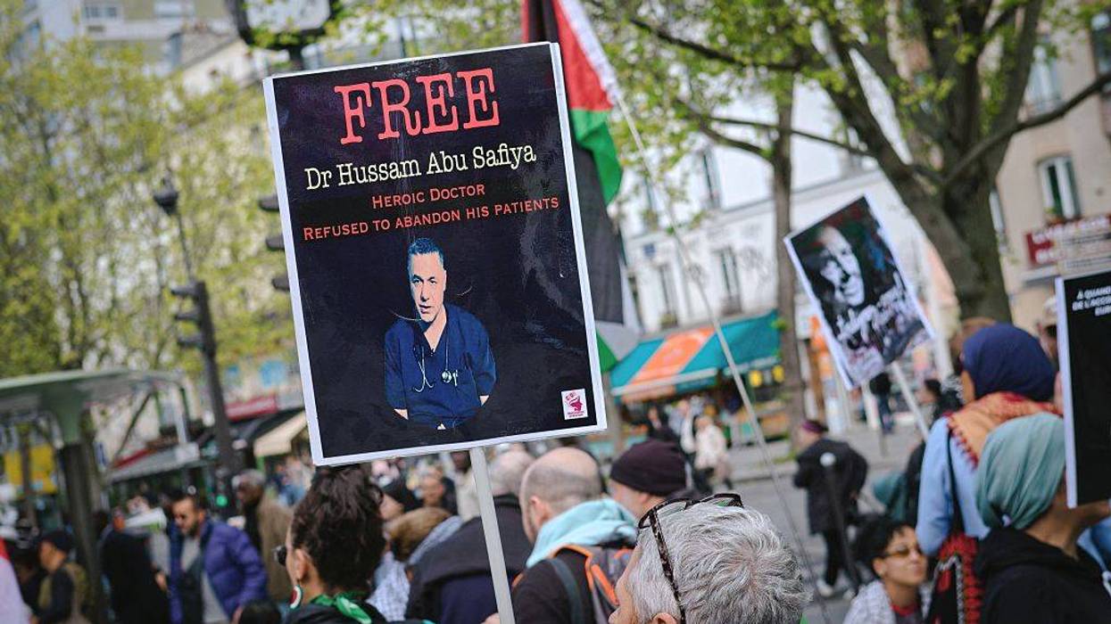 A sign calls for the release of Dr. Hussam Abu Safiya