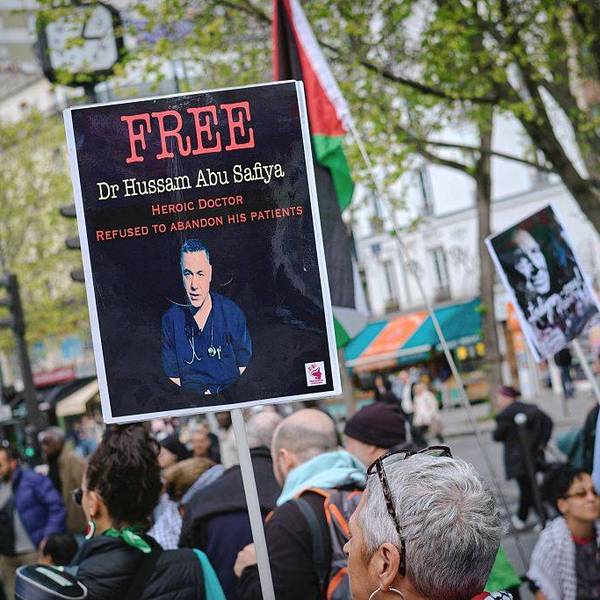 A sign calls for the release of Dr. Hussam Abu Safiya