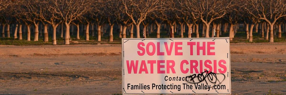 A sign in the San Joaquin Valley reads, "Solve the Water Crisis."