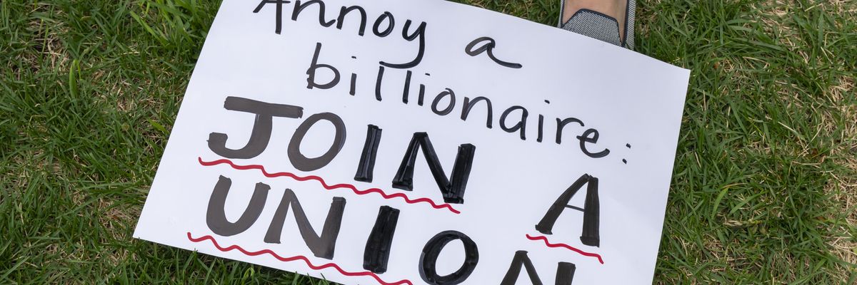 A sign is seen at a rally for immigrants' and workers' rights in St. Paul, Minnesota