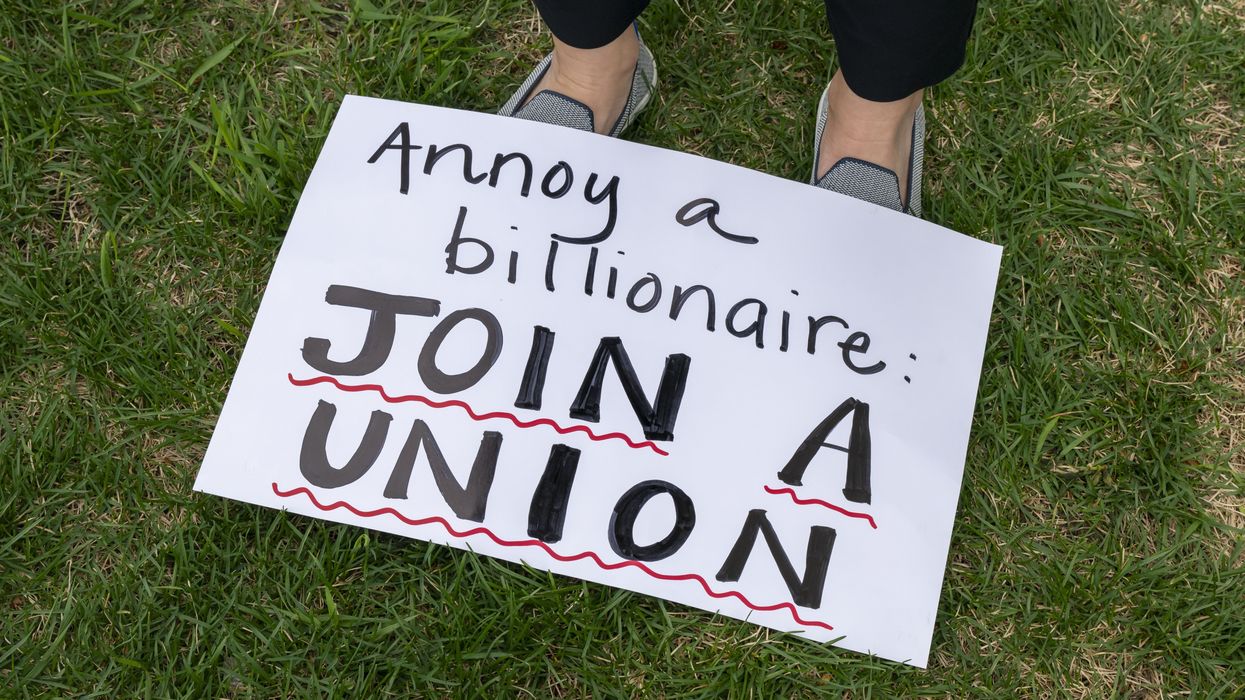A sign is seen at a rally for immigrants' and workers' rights in St. Paul, Minnesota