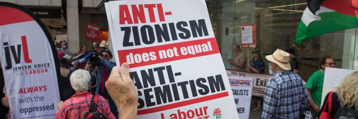 A sign reading "Anti-Zionism does not equal antisemitism"