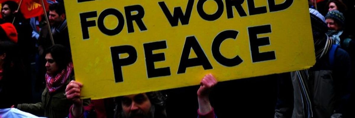 A sign reading "Let's Work For World Peace"