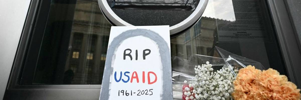 A sign reading "RIP USAID" is seen outside the agency's headquarters