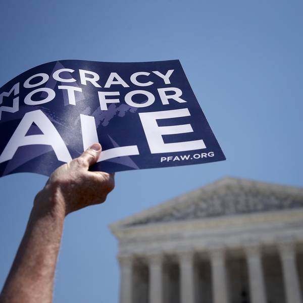 A sign reads "democracy is not for sale"