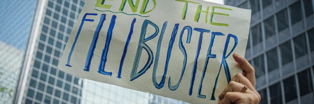 A sign reads, "End the filibuster" at a protest in New York