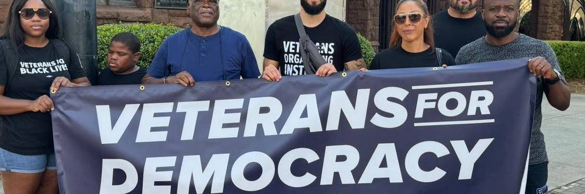 A sign reads, "Veterans for Democracy."