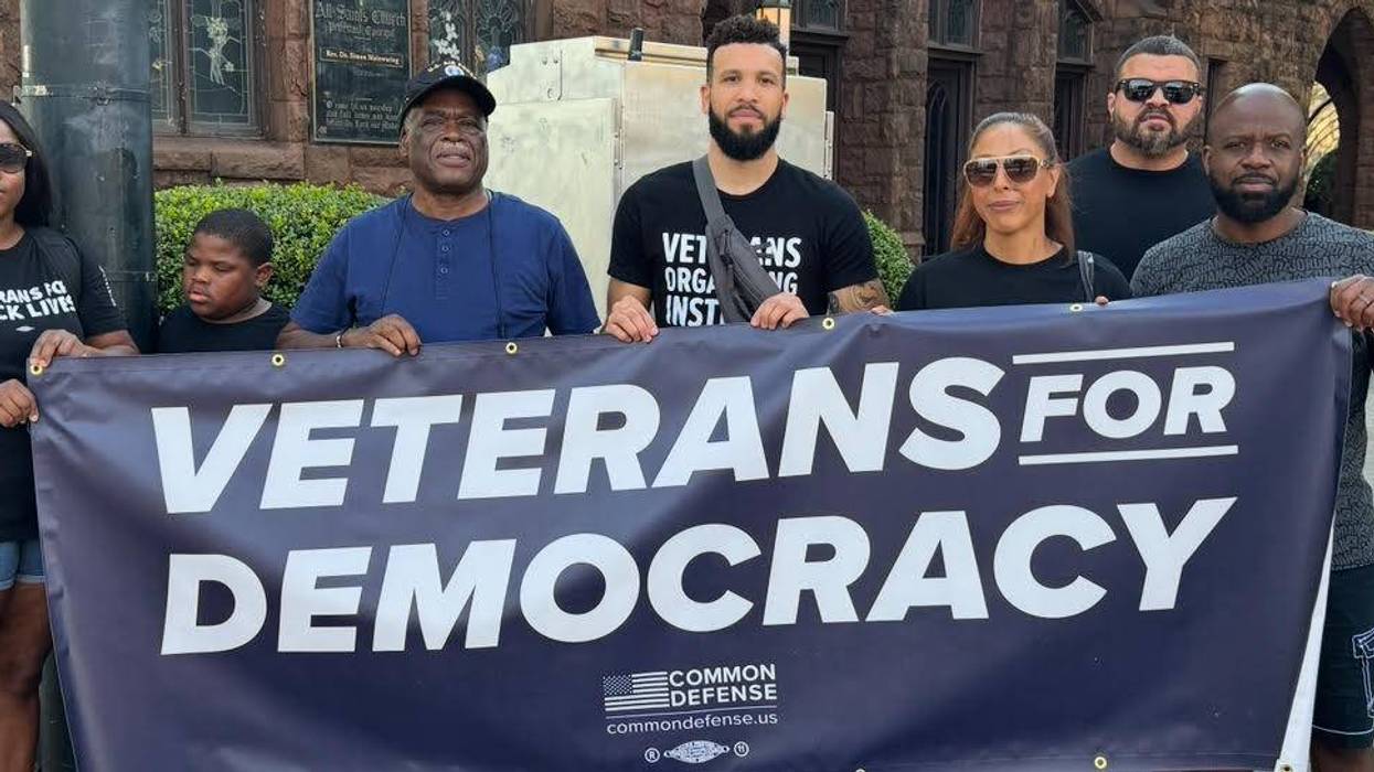 A sign reads, "Veterans for Democracy."