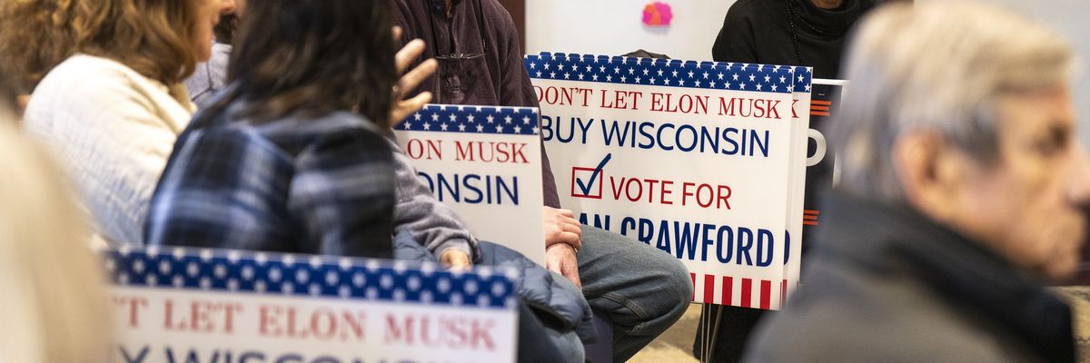 A sign says "Don't let Elon Musk Buy Wisconsin; Vote for Susan Crawford"