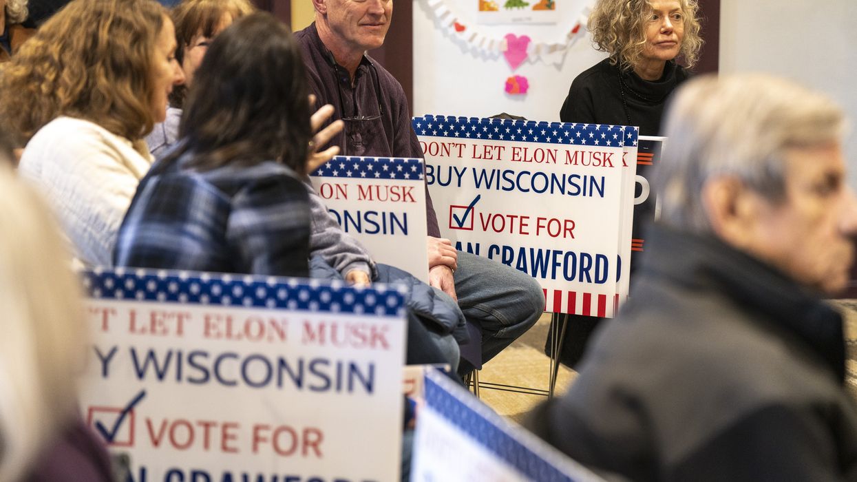 A sign says "Don't let Elon Musk Buy Wisconsin; Vote for Susan Crawford"