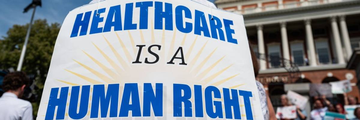 A sign says, "Healthcare is a human right."
